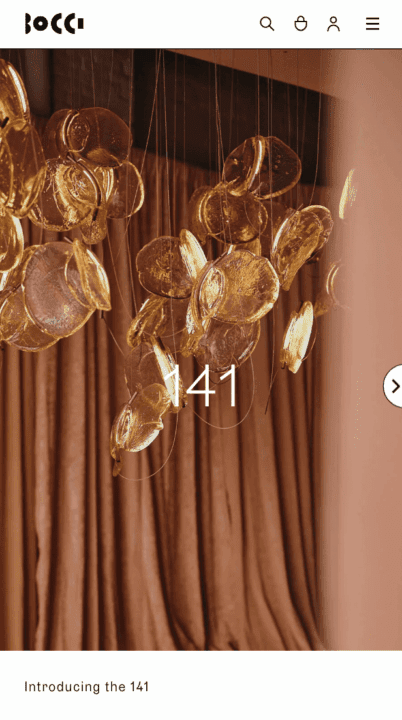 Elegant glass chandelier by Bocci, featuring golden discs, creating a warm, luxurious a...